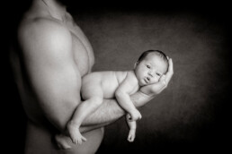 father holding his newborn baby
