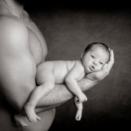 father holding his newborn baby