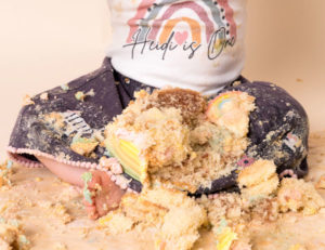 A mother holding her one-year-old, surrounded by warm, meaningful artwork that reflects their journey.