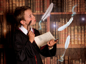 A child in wizard robes casting spells at immersive Wizard School photography experience in East Grinstead