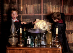 A child in wizard robes casting spells at immersive Wizard School photography experience in East Grinstead