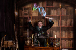 A child in wizard robes casting spells at immersive Wizard School photography experience in East Grinstead
