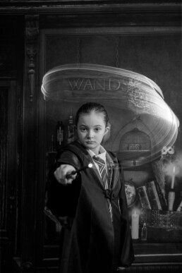 A child in wizard robes casting spells at immersive Wizard School photography experience in East Grinstead
