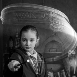 A child in wizard robes casting spells at immersive Wizard School photography experience in East Grinstead