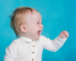 laughing baby boy at his first birthday portrait